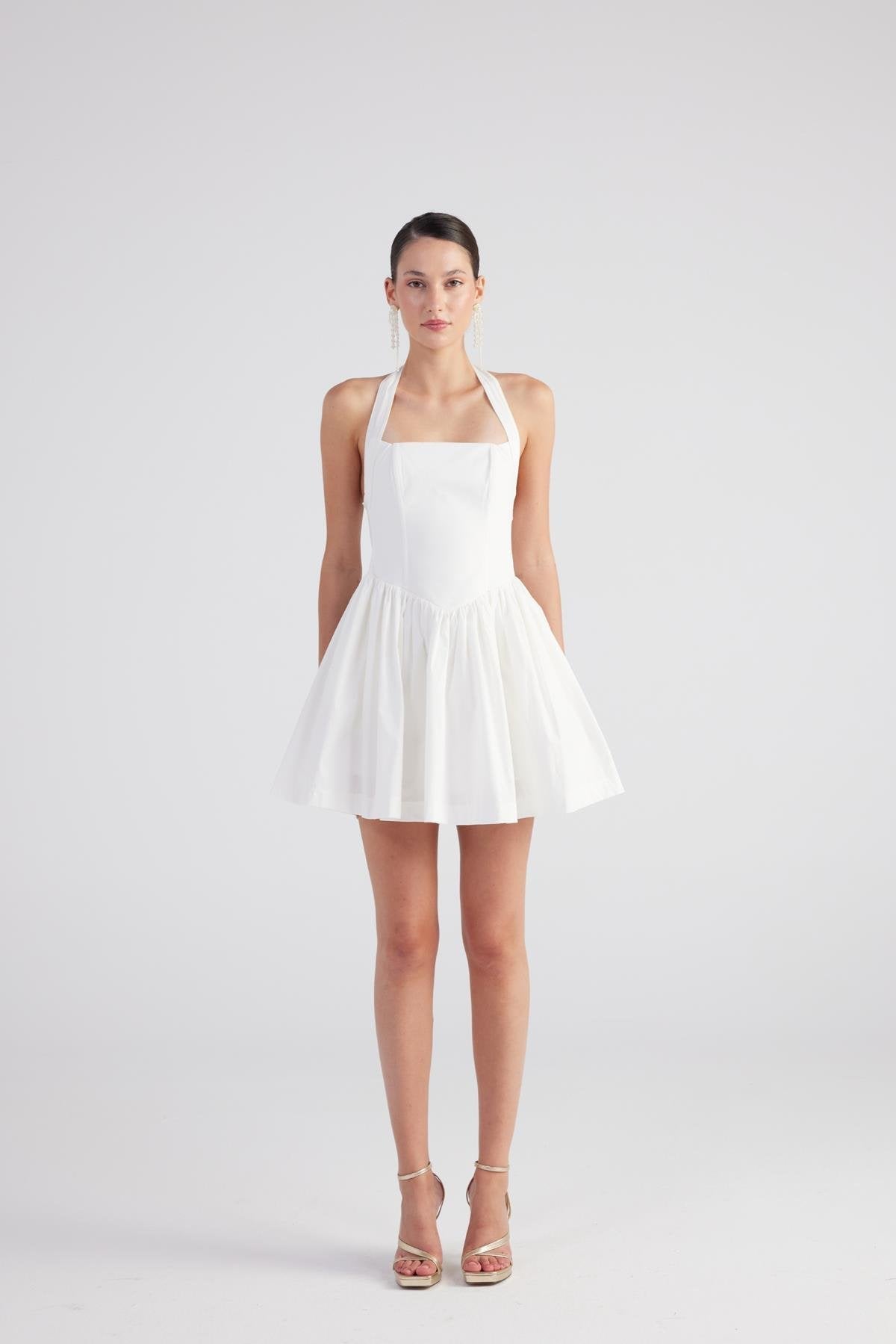 White pleated mini dress with square neckline and bow accent at the straps