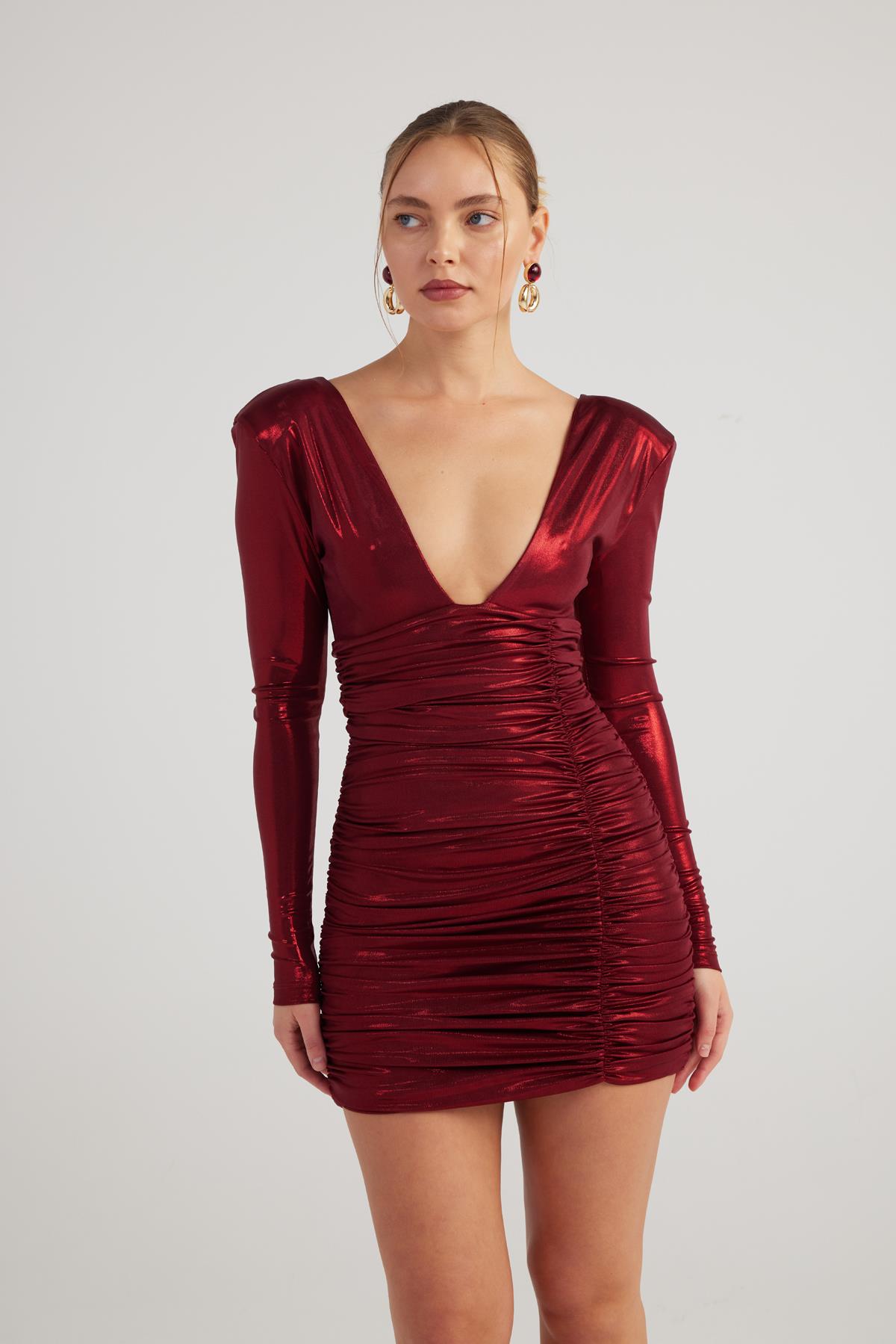 Burgundy ruched shiny mini dress with long sleeves and deep V-neck