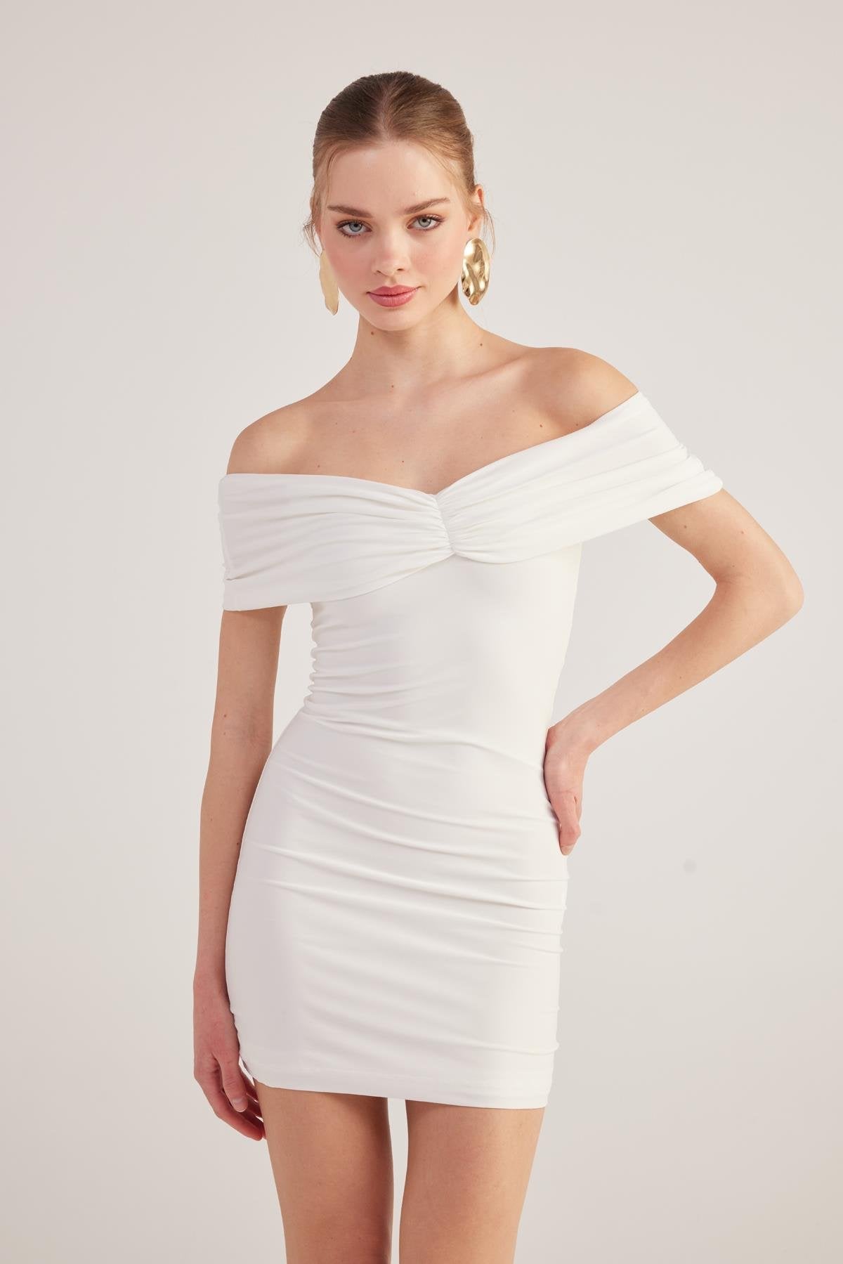 White off-shoulder mini dress with ruched bodice and sweetheart twist front