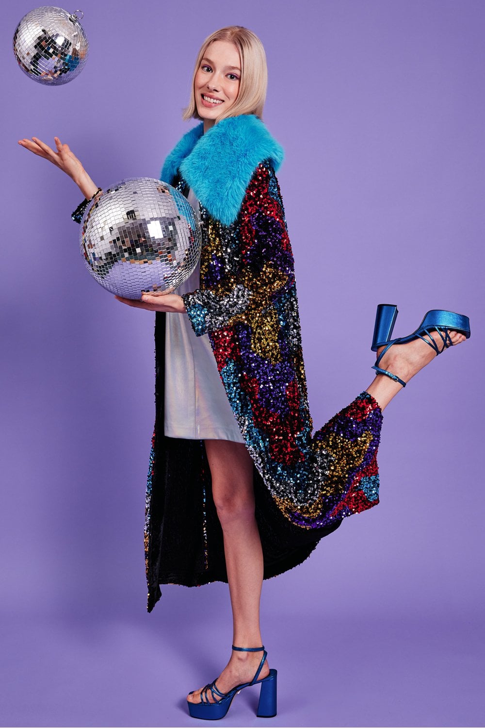 Sequined velvet trench coat with bright blue faux fur collar, open front, long hem
