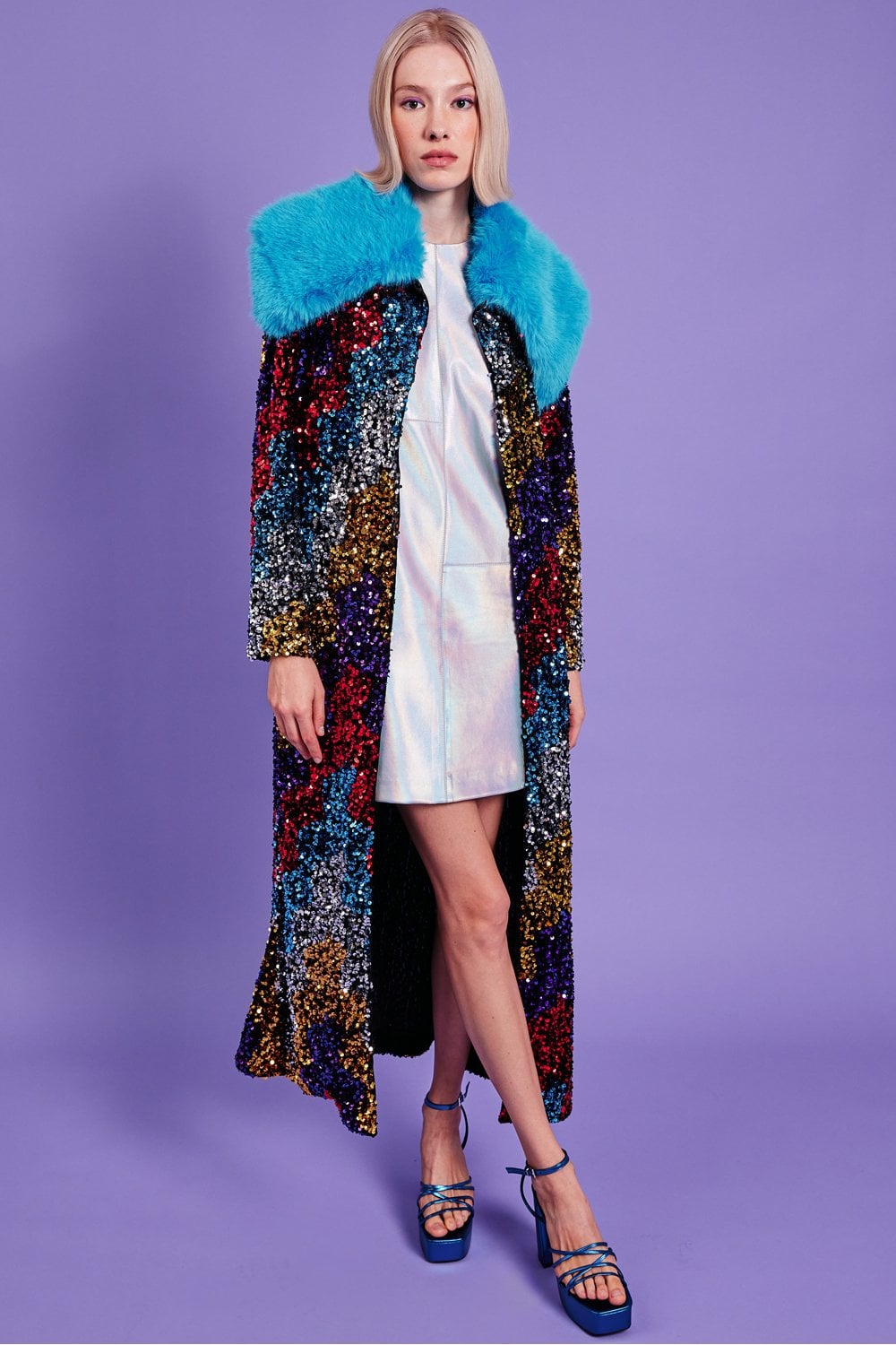 Black sequin velvet trench coat with blue faux fur collar, draped open front