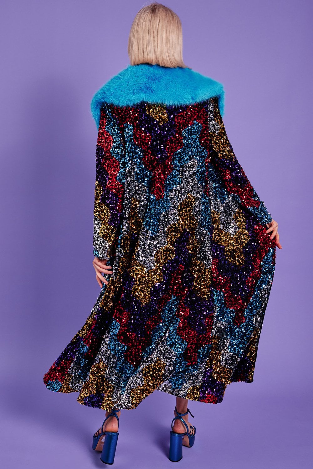 Back view sequin velvet trench coat with blue faux fur collar, flared long hem