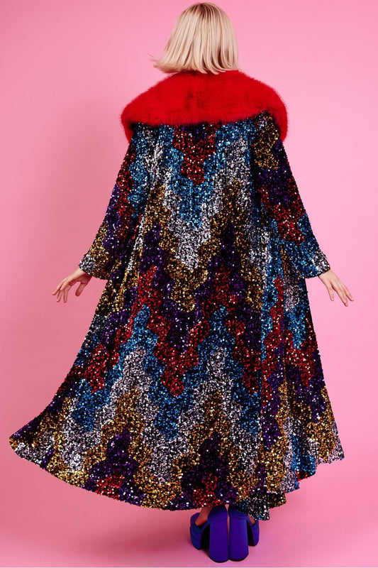 Long sequin trench coat in dark black with red faux fur collar, back view