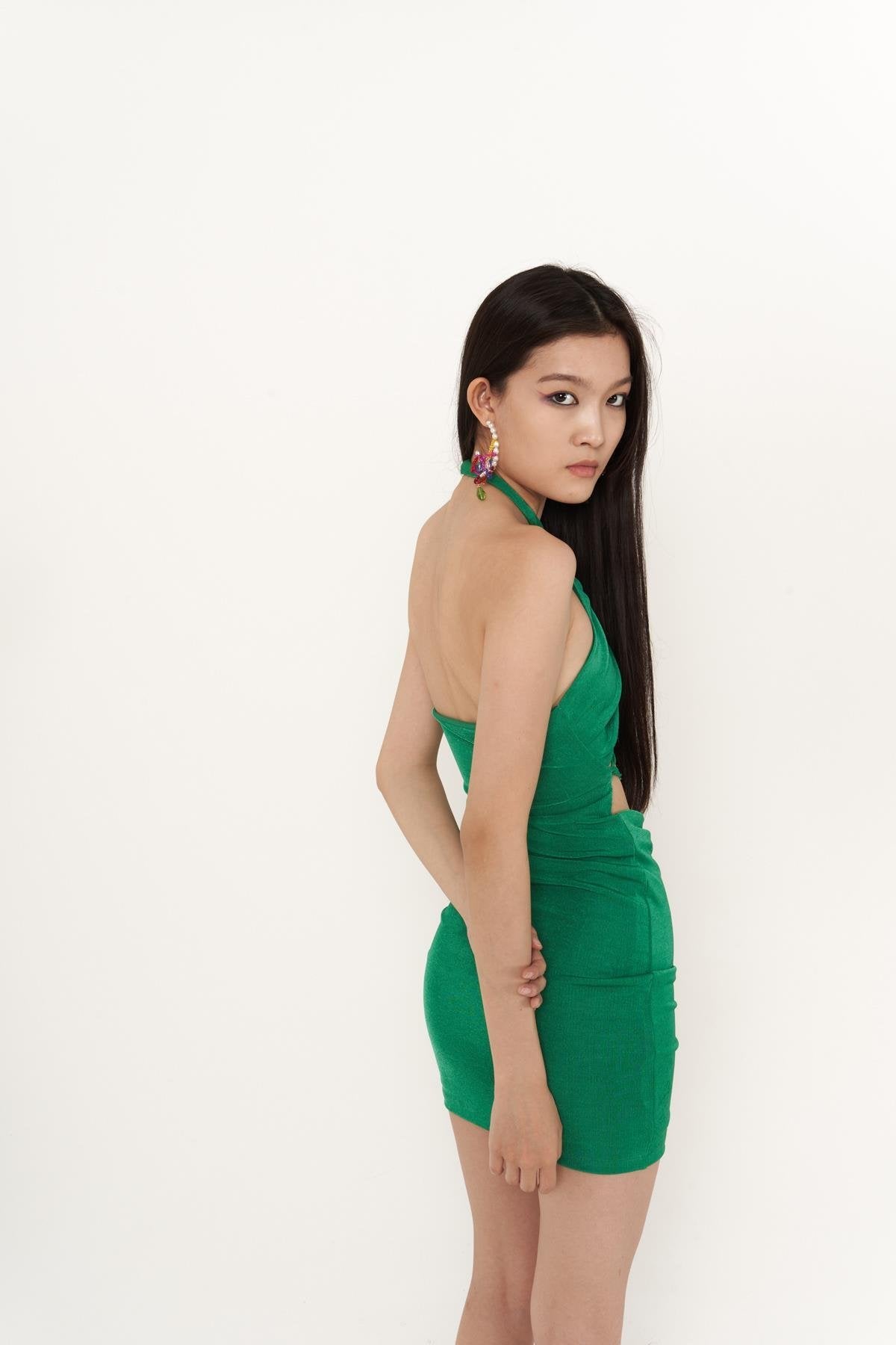 Green halter mini bodycon dress with open back straps and gathered side ruching