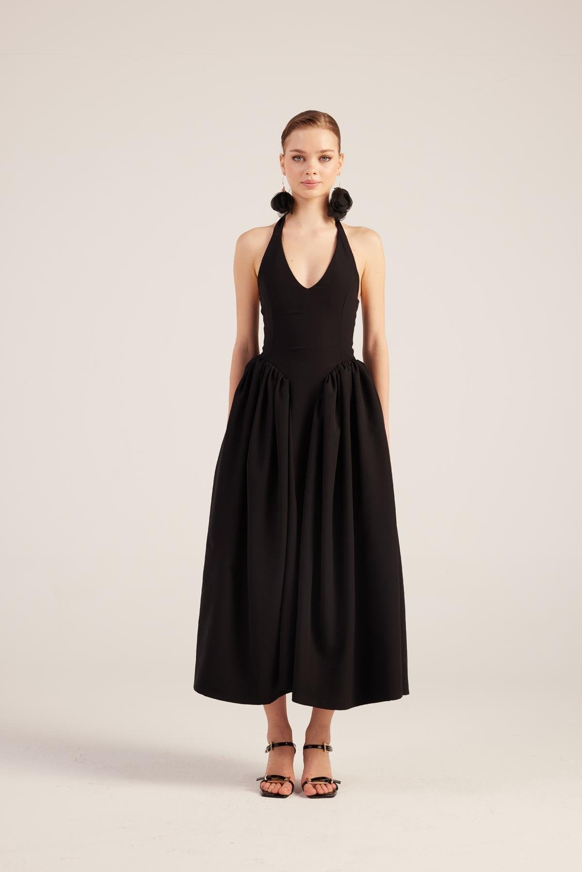Black princess style maxi dress with halter straps and full gathered skirt