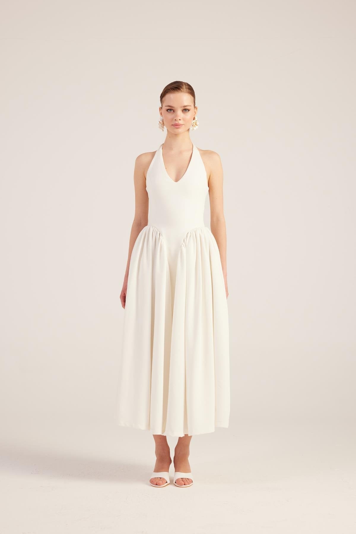 White sleeveless V-neck princess maxi dress with gathered waist and pleated full skirt