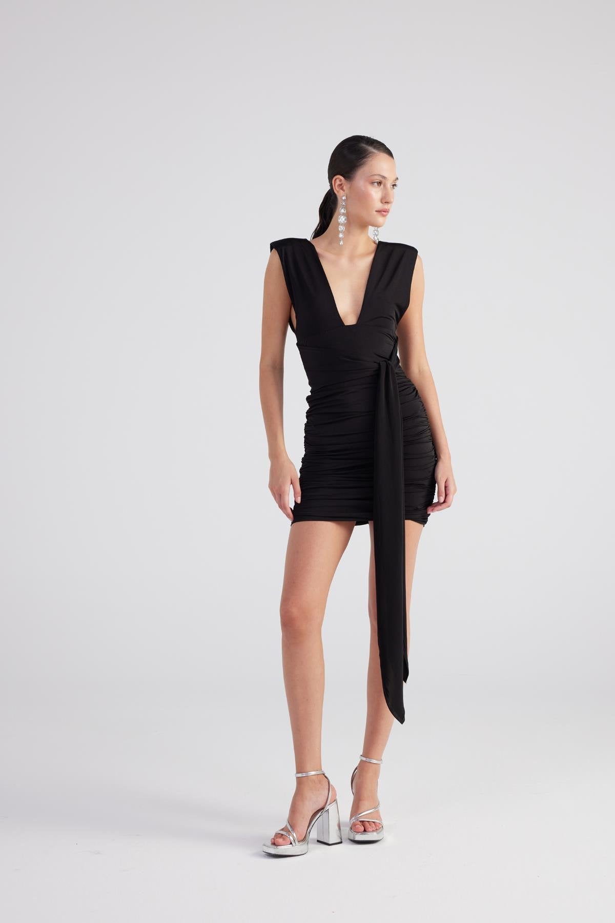 Black ruched mini dress, sleeveless V-neck and side slit with flowing tie