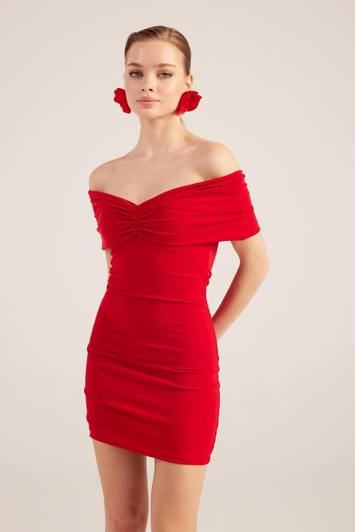 Red off-shoulder bardot mini dress with ruched bodice and cinched waist, short length