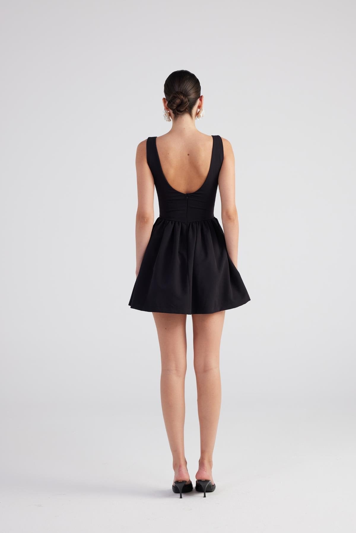 Black sleeveless pleated mini dress, scoop back and gathered waist