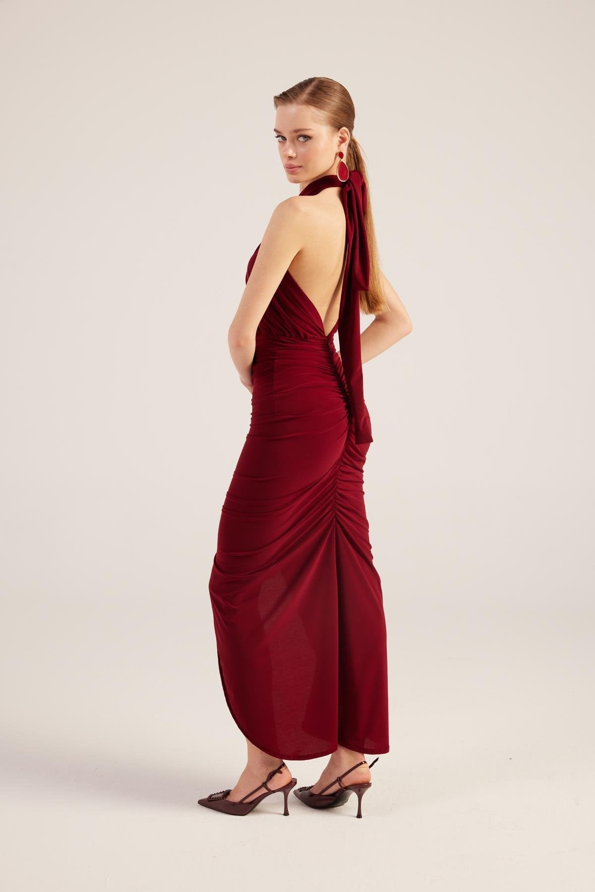 Burgundy backless halter maxi dress with gathered skirt and front-side drape