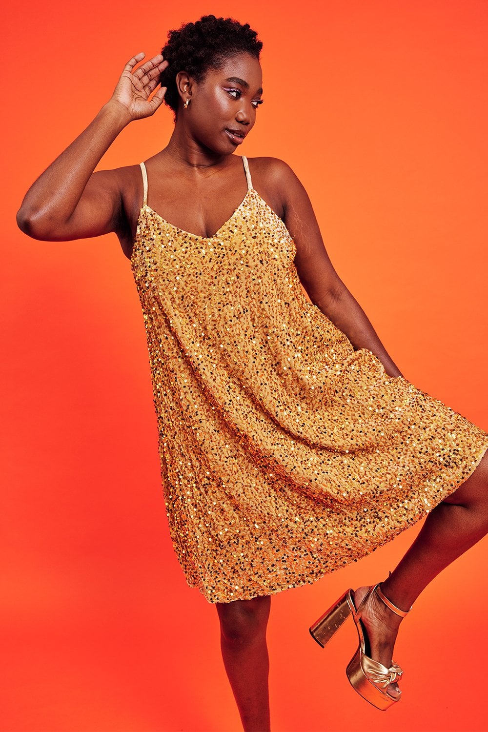 Gold sequin cami swing dress side view, flared hem