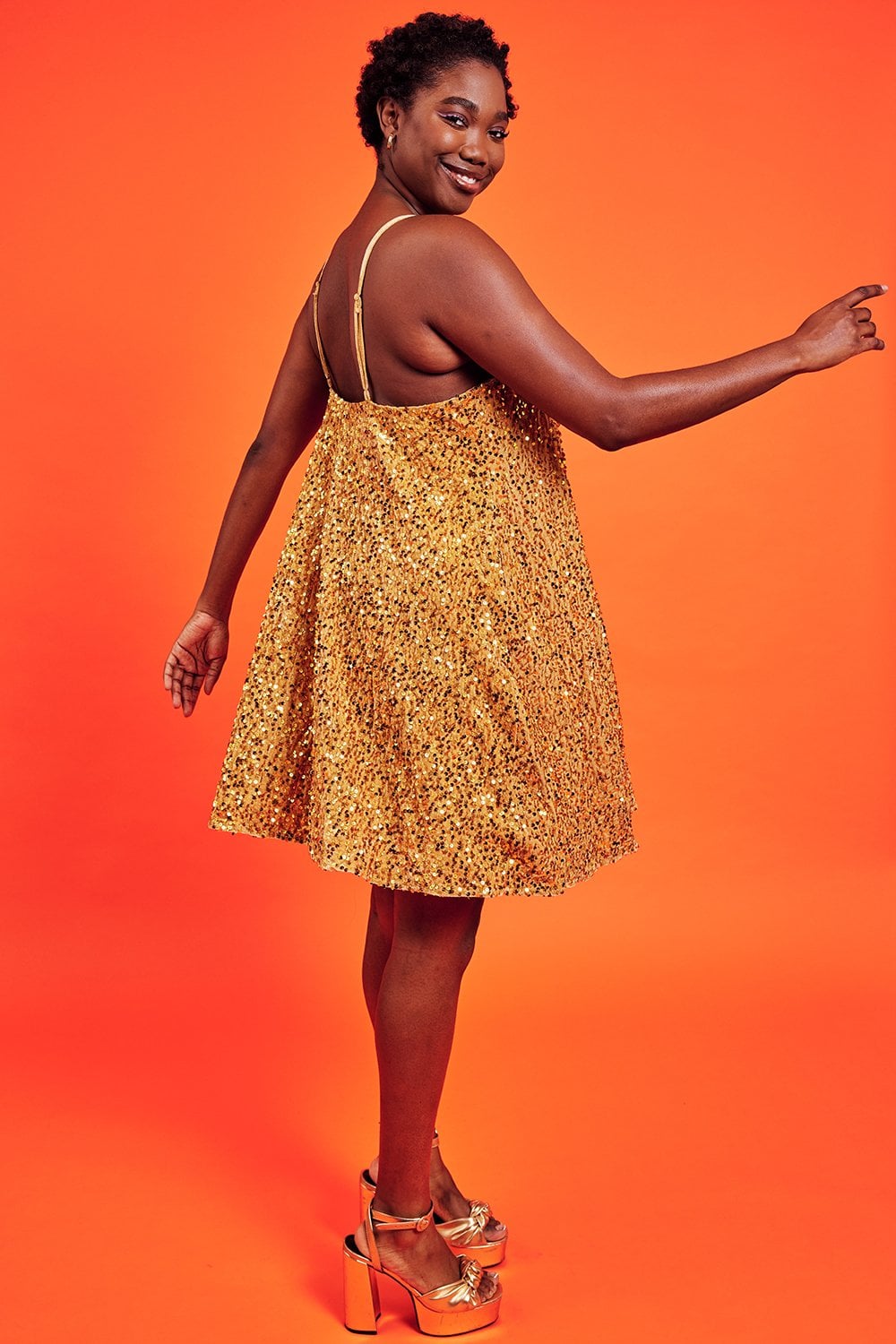 Gold sequin cami swing dress 3/4 profile, thin straps, swing skirt