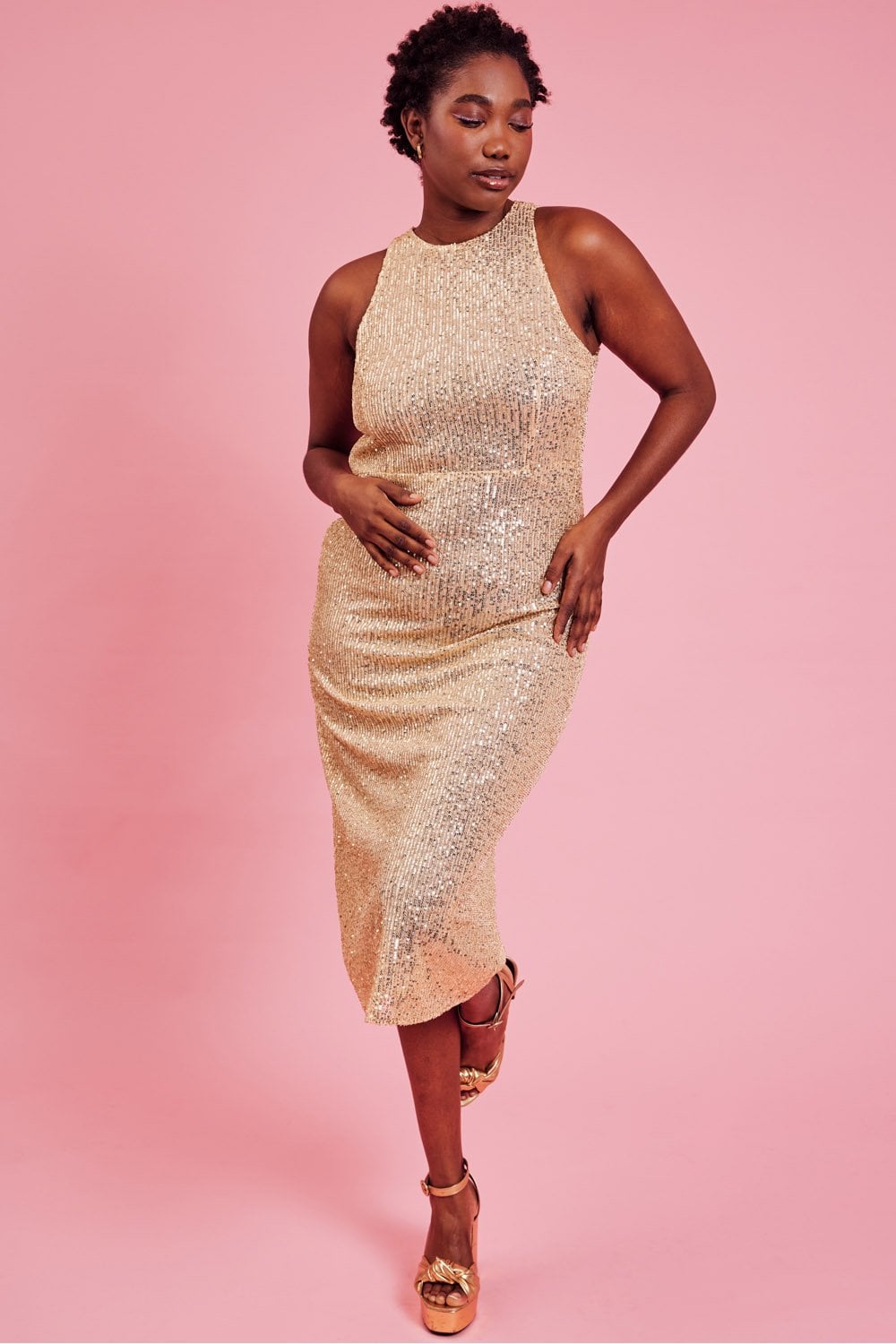 Gold sequin sheath dress with high halter neckline, sleeveless fitted midi length