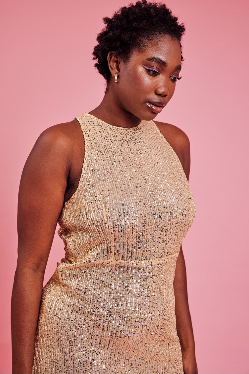 Gold sequin sheath dress close-up with high halter neckline, sleeveless fitted