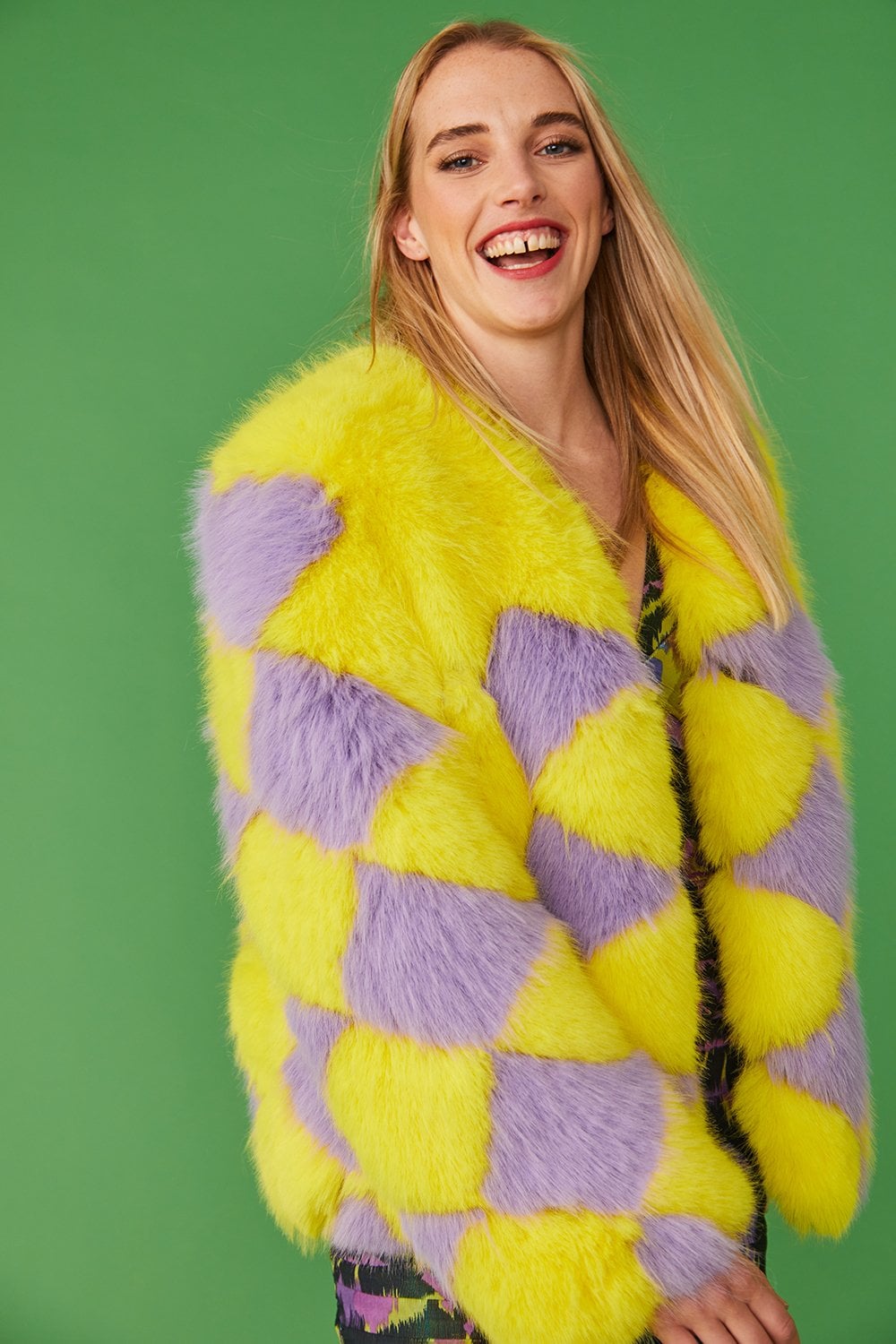 Yellow and purple diamond-pattern faux fur jacket, close-up of collar and shoulders