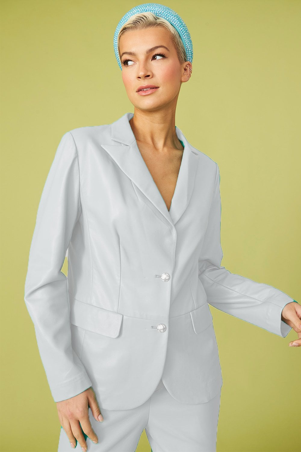 White vegan leather blazer with notch collar, single-breasted button, and side pockets