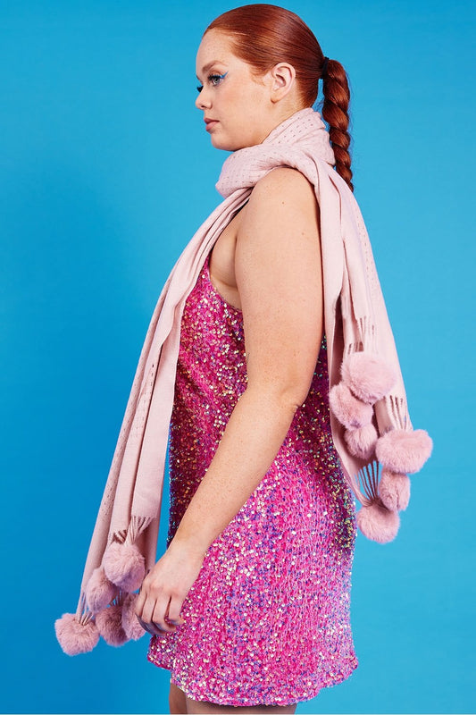 Pink sequined cami dress side view with draped scarf and pom-pom trim